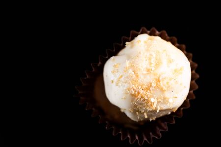 One Single Handmade Chocolate Praline Close Up View. Dark Background with Copy Space.の写真素材
