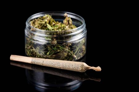 Recreational Prescription Medical Marijuana Joint and Cannabis Flower Buds in Jar.の写真素材