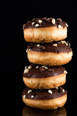 Chocolate Donuts or Doughnuts Tower on Dark Background. Copy Space for Text.の写真素材