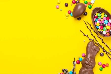 Easter Background. Chocolate Rabbit and Eggs with Colorful Candy. Copy Space on Flat Lay Design.
