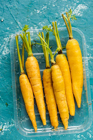 Yellow Mini Carrots in Plastic Tray. Farm Fresh Food.