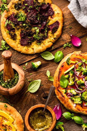 Homemade Small Vegetarian Pizza on Wooden Rustic Table. Top Down View.の写真素材