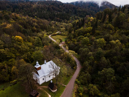 Old Church in Lopienka near Bieszczady Mountains. Autumn Colors. Drone View.の写真素材
