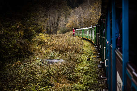 Retro Train Trough Wilderness of Bieszczady Mountains in Poland at Autumn. Dramatic Weather and...