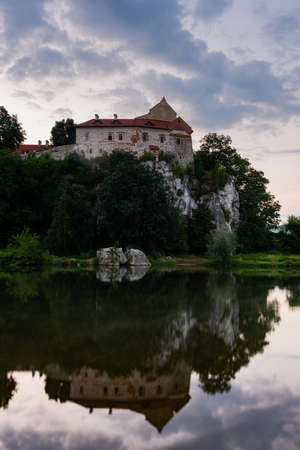 Picturesque Tyniec near Krakow, Poland. Benedictine Abbey, Monastery and Church on the Cliff . Clouds Reflection in Vistula River at Sunriseのeditorial素材