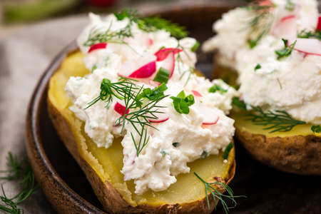 Jacked Potato with Cottage Cheese and Radish and Chive. Polish Traditional Pyry z Gzikiem Dish.の写真素材