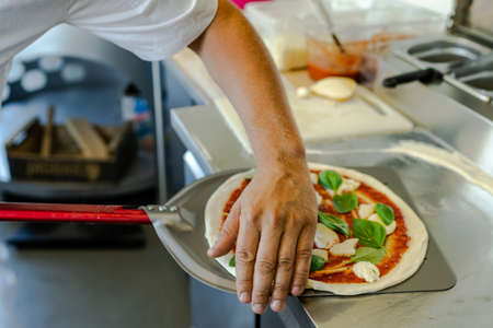 Pizza Chef Preparing Pizza in Mobile Food Truck.の写真素材