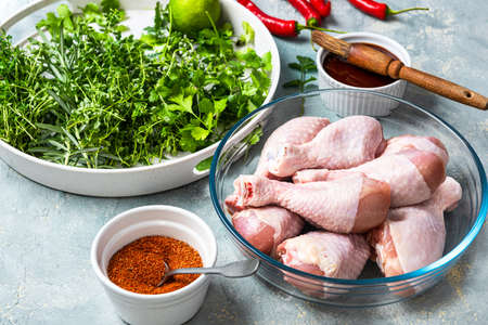 Raw Chicken Legs Drumsticks with Skin in Bowl. Food for BBQ Grill Preparation.の写真素材