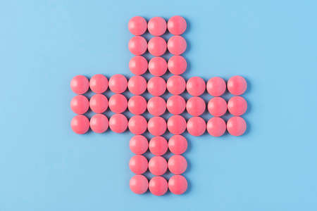 Pharmacy Cross Made of Red Pills Medicine Tablets.