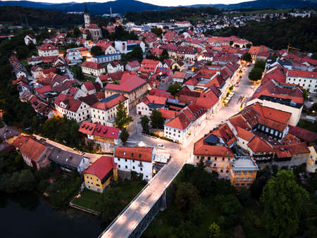 Illuminated at Night Novo Mesto in Lover Carniola Region in Slovenia at River Krka Bend. Drone View.