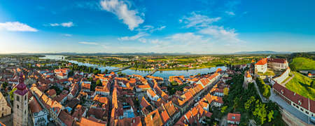 Aerial Panorama over Ptuj Townscape, Ptuj Castle and River Drava in Slovenia.のeditorial素材
