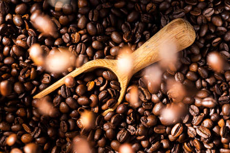 Roasted Coffee Beans Background Texture, Wooden Spoon and Flying Beans.の写真素材