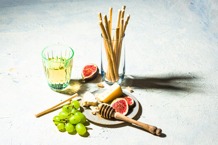 Cheese Appetizer with Figs and Grapes on Table.