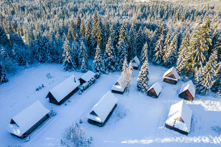 Traditional Polish Highlander Wooden Hut in Winter Forest.