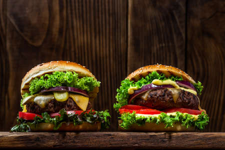 Two Burgers on Wooden Background Close Up View.の写真素材