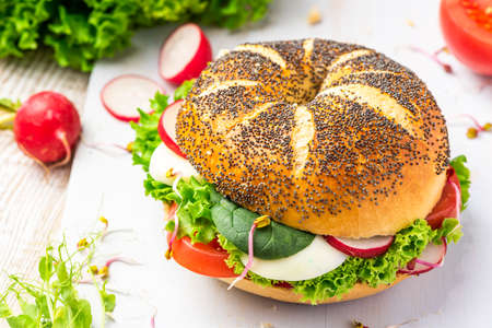 Fresh Bagel with Spring Vegetables. Healthy Breakfast Idea.