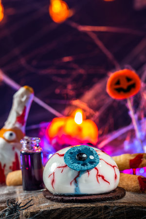 Halloween sweet food on decorated table. Spooky and funny party idea.の写真素材