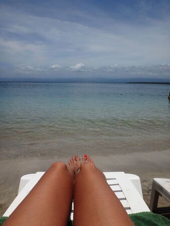 feet on the caribbean beachの写真素材