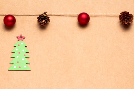 Christmas greetings card with a garland of balls and pineapples and green cardboard tree. Space for copying. Advertising bannerの写真素材
