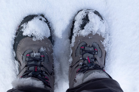 Snow boots full of snow, zenithal plane. Concept of walking in winter.の写真素材