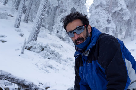 man hiking for a snowy mountain. Feeling of loneliness and calm. Concept of improvement and challenge.の写真素材