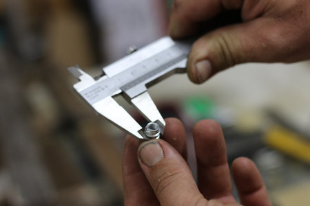 Caliper in the hands of a craftsman, close-up