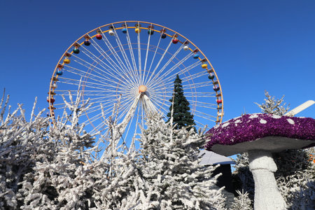 Huge Ferris Wheel and Christmas Elf Mushroom at the Christmas Market in Le Barcarès, France, on a sunny dayの写真素材