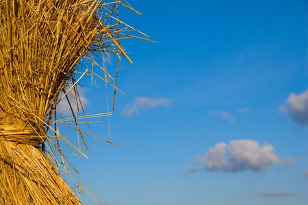 Bundle of hay with a blue skyの写真素材