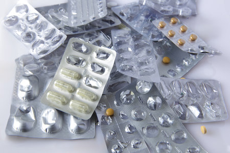 View image of used empty blister packs. Group of heap of prescription drug packages. Half empty half...