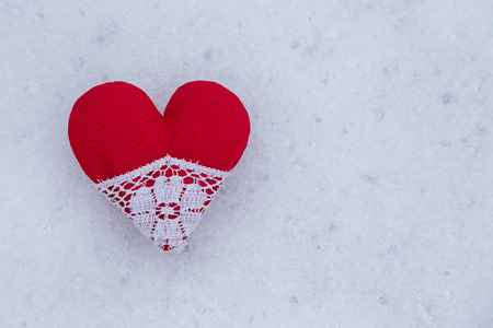 red heart in a snow backgroundの写真素材