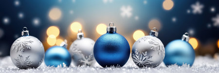 Blue and silver christmas baubles on bokeh backgroundの素材