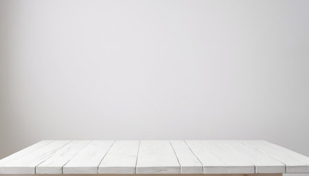 Empty white wooden table over gray wall background, product display montageの素材