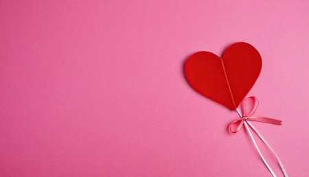 Red paper hearts on a pink background. Valentine's Day concept.の素材