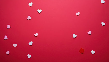 Valentine's Day background with white hearts on a red backgroundの素材