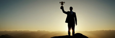 Businessman holding a trophy on top of a mountain. Success concept.の素材