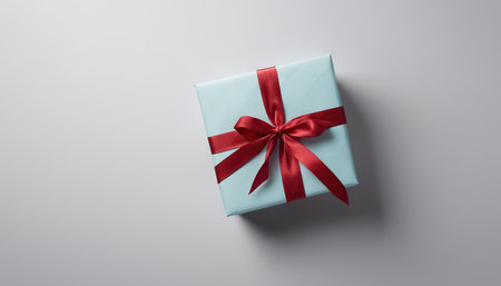 Photo for Blue gift box with red ribbon on gray background. Top view. - Royalty Free Image