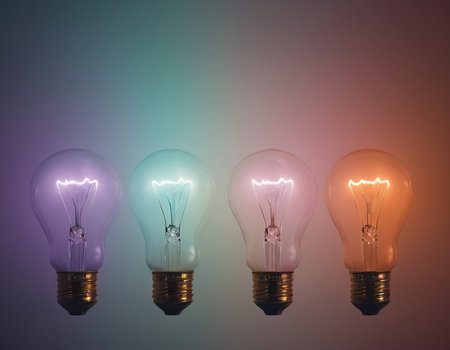 Group of incandescent light bulbs on a colored background with copy spaceの素材