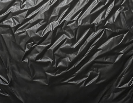 Black crumpled fabric texture. Abstract background and texture for design.の素材