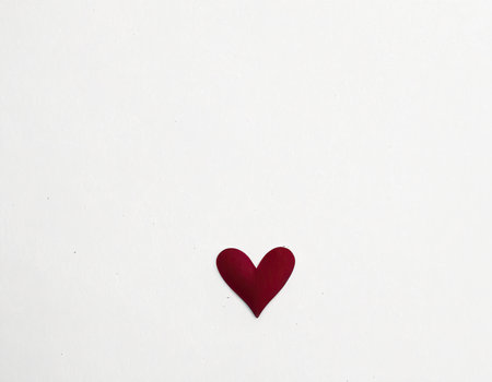Red heart on white paper background. Valentines day concept. Copy space.の素材