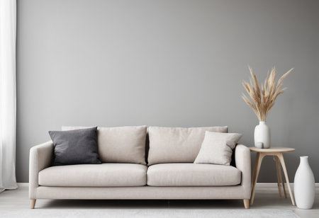 Interior of modern living room with beige sofa and vase with dried flowersの素材