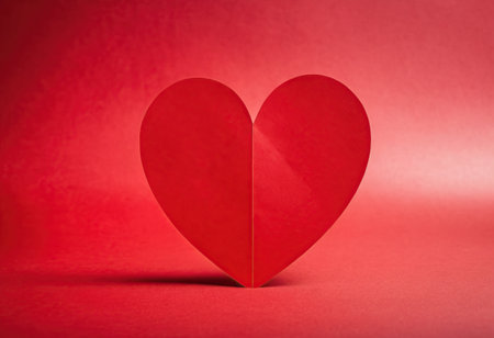 Red paper heart on a red background. Valentine's day concept.の素材