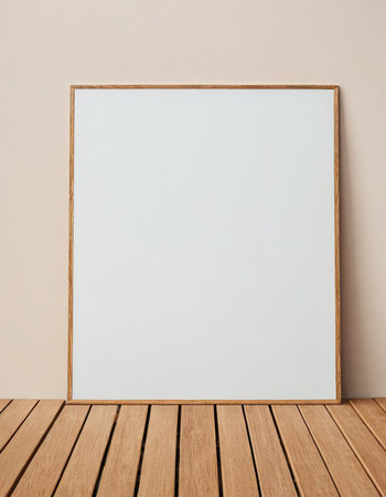 Blank picture frame on wooden table and beige wall background.の素材