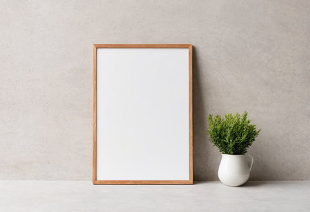 Wooden frame mockup on concrete background with plant in vaseの素材