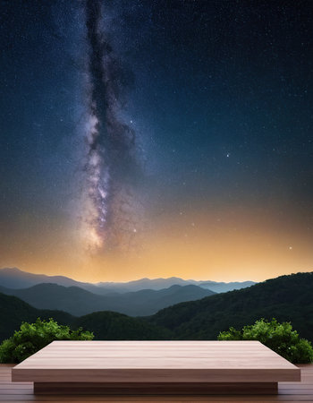 Wooden table with milky way in the night sky and mountain backgroundの素材