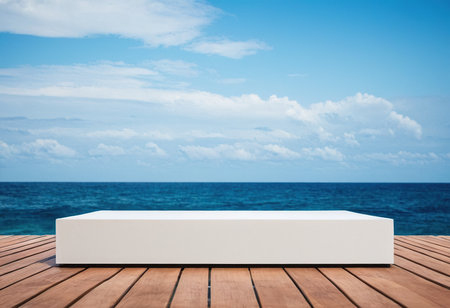 Empty white podium on wooden deck with sea and blue sky background.の素材