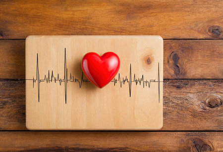 Heart and cardiogram on wooden background. Health care and medical conceptの素材