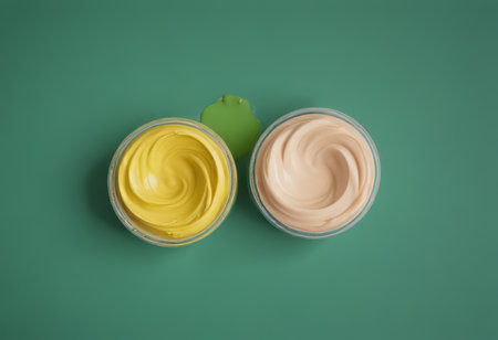 cosmetic cream in a jar on a green background. top viewの素材