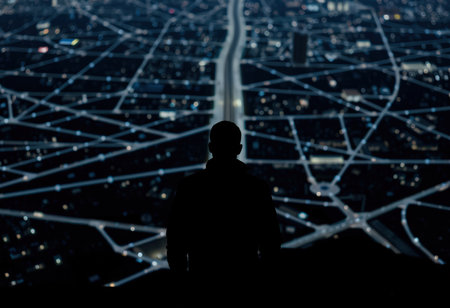 Silhouette of businessman looking at abstract network connection on night city backgroundの素材