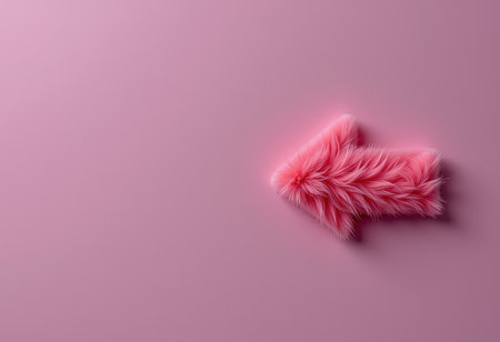 Fur pink arrow on a pink background. Minimal concept.の素材
