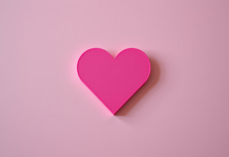 Pink paper heart on pink background. Valentines day and love conceptの素材